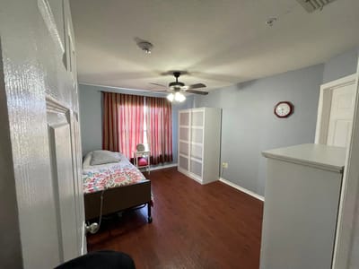 Cozy private room with bed and furnishings.