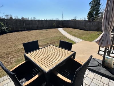 Outdoor seating area with a table and chairs.