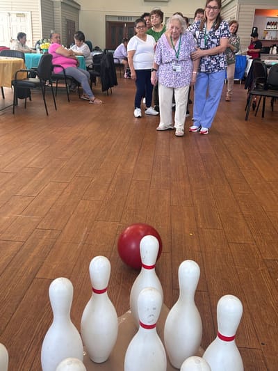 Residents participating in a bowling activity