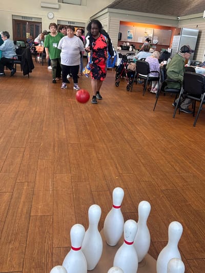 Residents participating in a bowling activity.