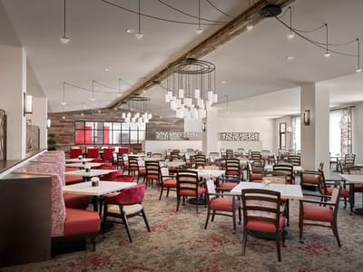 Modern dining room with red seating and stylish decor.