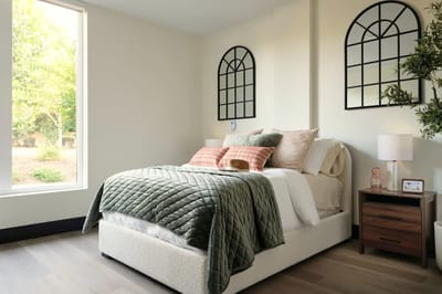 Cozy bedroom with natural light and modern decor.