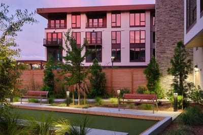 Outdoor landscaped area with seating and lighting.
