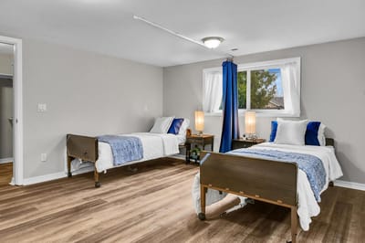 Two twin beds in a well-lit room