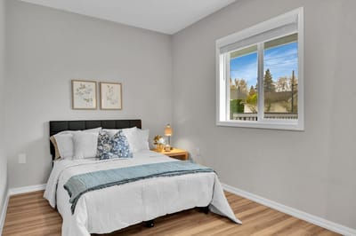 Bright private resident bedroom with bed and decor