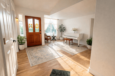 Bright entryway with piano and seating area