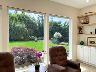 Bright room with large windows overlooking a garden.