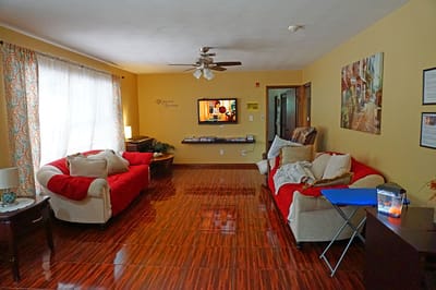 Cozy lounge area with red sofas and a TV