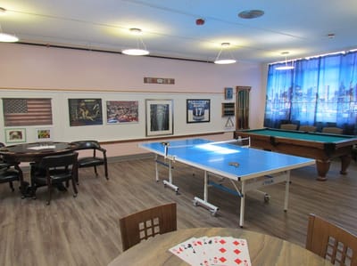 Magnolia Adult Day Care, assisted living in Fort Lee, NJ — Activity room with ping pong table and pool table