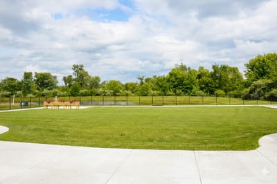 Spacious outdoor area with green grass and trees