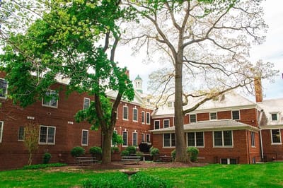 Exterior view of a brick building surrounded by trees