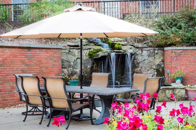 Outdoor seating area with a fountain and flowers