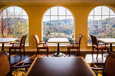 Bright common area with large windows overlooking nature