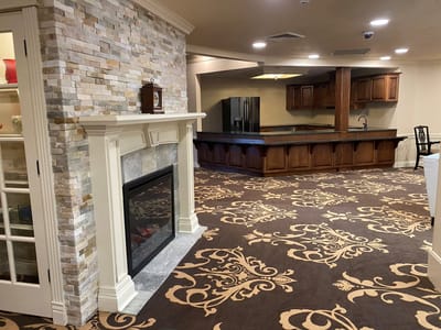 Interior common area with a fireplace and kitchen