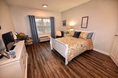 A cozy resident room featuring a bed and TV