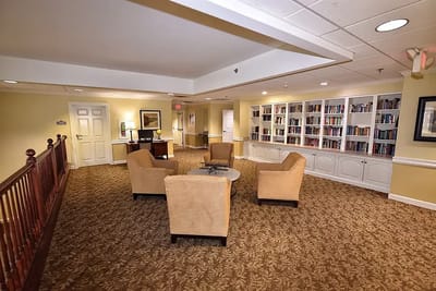 A well-lit common area with seating and bookshelves