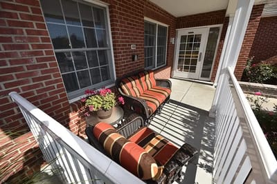 Outdoor seating area with porch and potted plants
