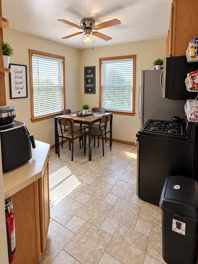 Bright kitchen area with a dining table and windows