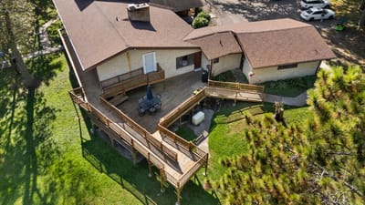 Aerial view of a building with a wooden deck and grassy area