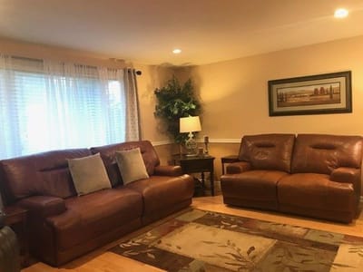 Cozy lounge area with leather sofas and a lamp