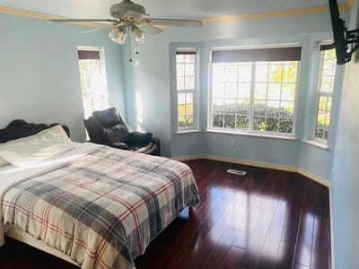 Cozy bedroom with a view and wooden floors
