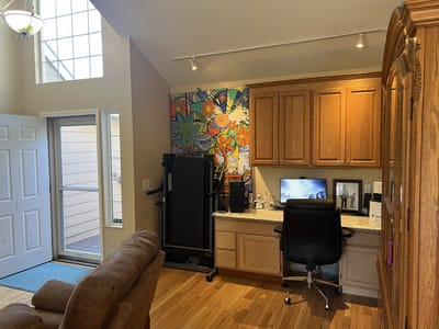 Cozy interior living space with a desk and exercise equipment