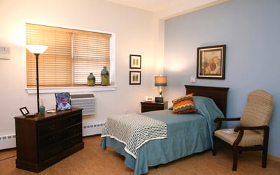 Cozy resident room with a single bed and personal touches