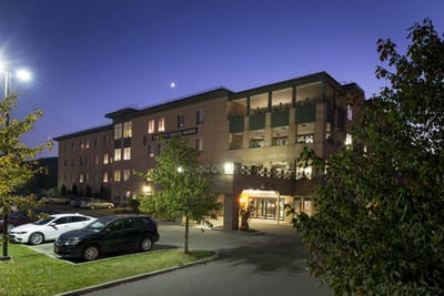 Exterior view of Hilltop Manor at dusk