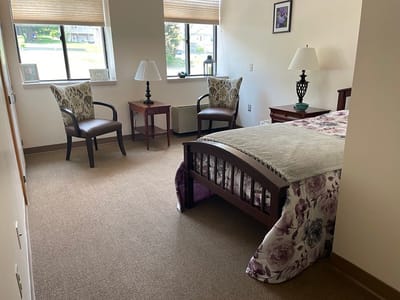 Cozy resident room with seating area and bed