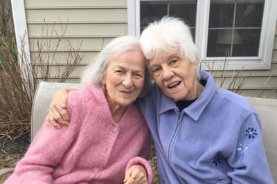 Two residents smiling together outdoors