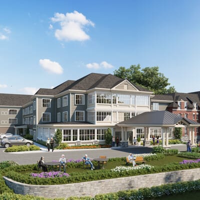 Exterior view of a senior living facility with residents outside