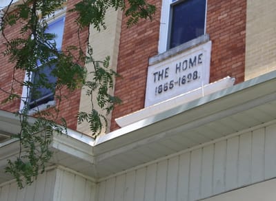 Exterior view of a historic building labeled 'THE HOME'