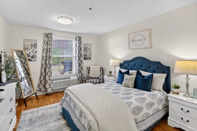 Cozy resident room with blue bedding and decorative accents