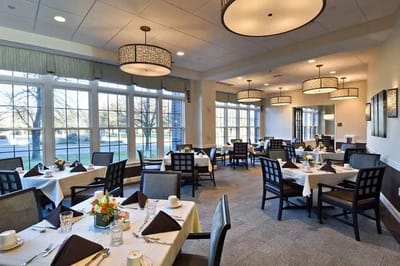 Elegant dining room setup with tables and flowers