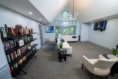 Bright common area with seating and bookshelves