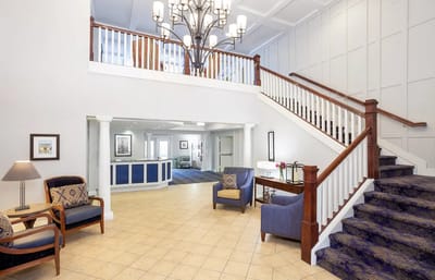 Bright, spacious lobby area with a staircase