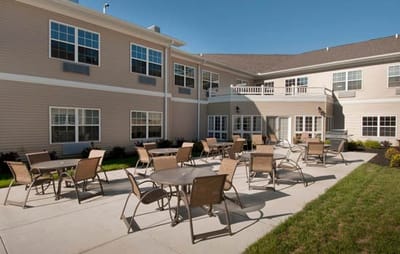 Outdoor patio with tables at Heathwood Assisted Living
