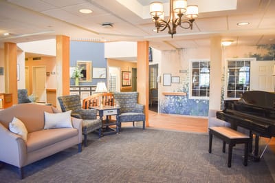 Comfortable common area with seating and piano