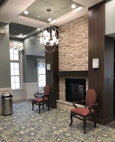 Interior view of a common area with chairs and fireplace