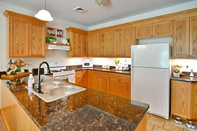 Bright kitchen area with wooden cabinets and modern appliances