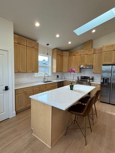 Modern kitchen interior with wooden cabinets and island