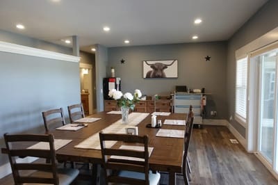 Dining area with a large table and floral centerpiece