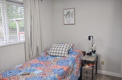 Cozy resident room with bed and nightstand