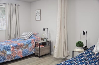Cozy resident room with two beds and bright decor