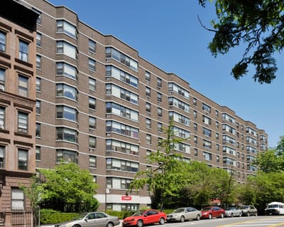 Exterior view of a senior living facility with greenery