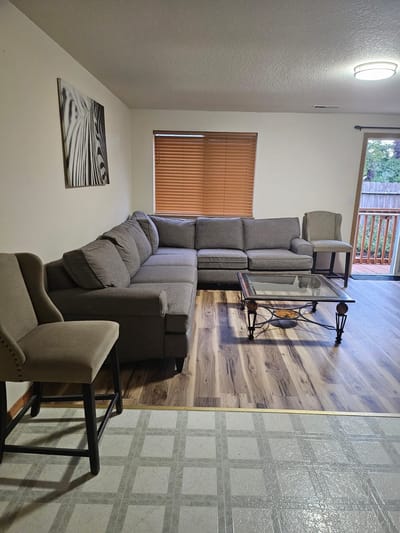 Cozy living room with gray sectional sofa and chairs