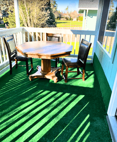 Table and chairs on a green outdoor patio