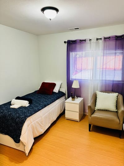 Cozy private room with single bed and chair
