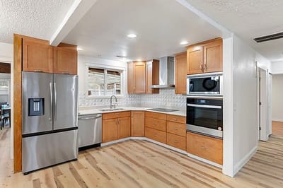 Modern kitchen interior with wooden cabinetry and appliances
