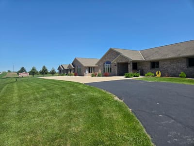 Exterior view of Denmark Family Living facility with green lawn